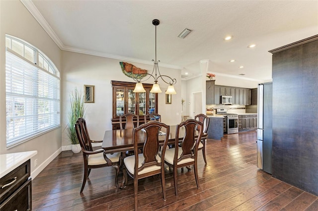 dining area featuring a textured ceiling, dark hardwood / wood-style floors, and crown molding