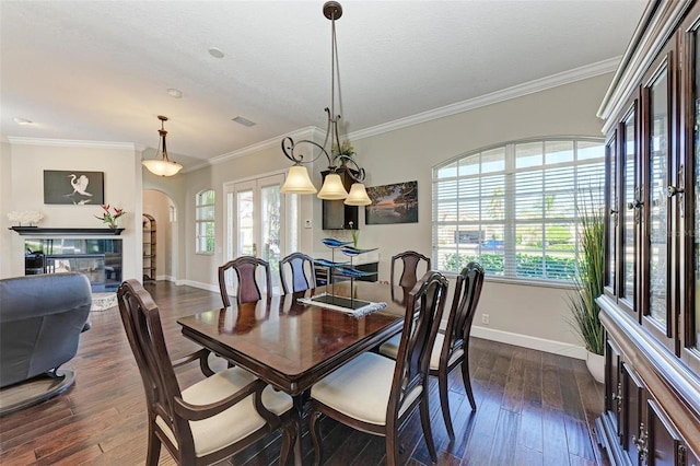 dining area featuring french doors, ornamental molding, a textured ceiling, a chandelier, and dark hardwood / wood-style floors