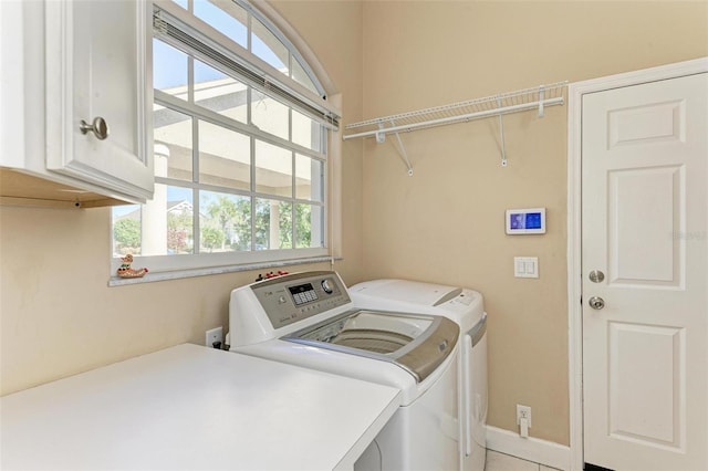 laundry room with cabinets and separate washer and dryer