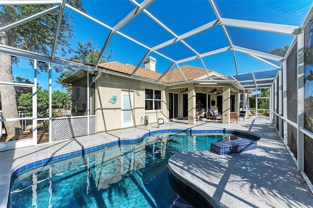 view of swimming pool featuring a lanai, ceiling fan, and a patio