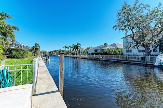 dock area with a yard and a water view