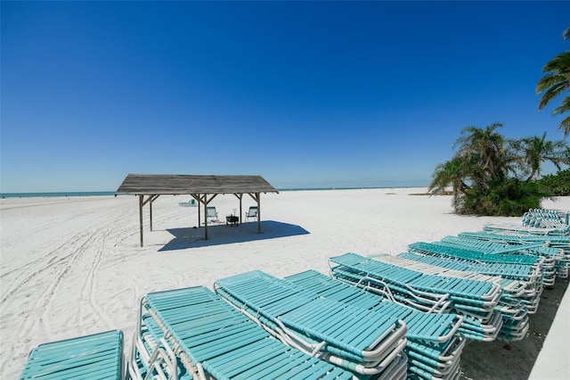 exterior space featuring a water view and a beach view