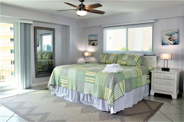 tiled bedroom with access to outside and ceiling fan