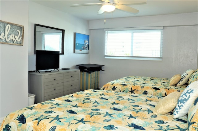 bedroom featuring multiple windows and ceiling fan