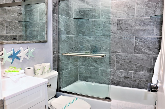 full bathroom with vanity, toilet, and shower / bath combination with glass door