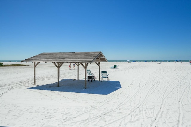 view of dock featuring a view of the beach and a water view