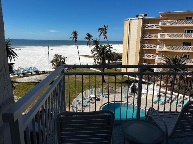 balcony with a view of the beach and a water view