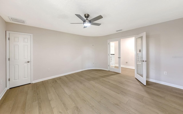 unfurnished room with ceiling fan, french doors, and light hardwood / wood-style floors