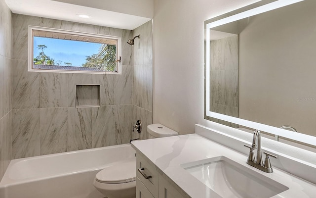 full bathroom with vanity, tiled shower / bath combo, and toilet