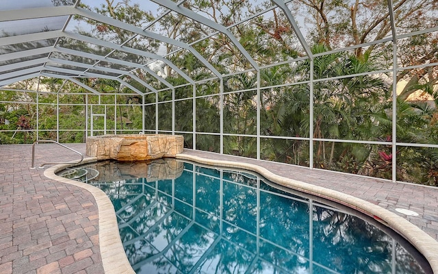 view of pool featuring a lanai and a patio