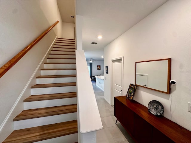 stairway with tile patterned flooring and ceiling fan