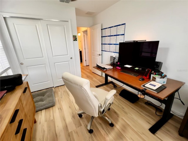 office with light hardwood / wood-style flooring