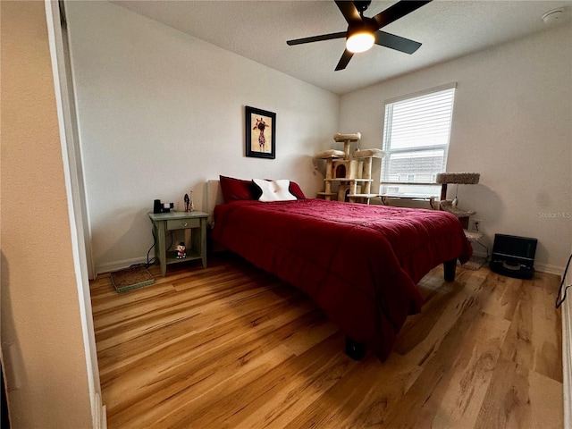 bedroom with ceiling fan and light hardwood / wood-style flooring