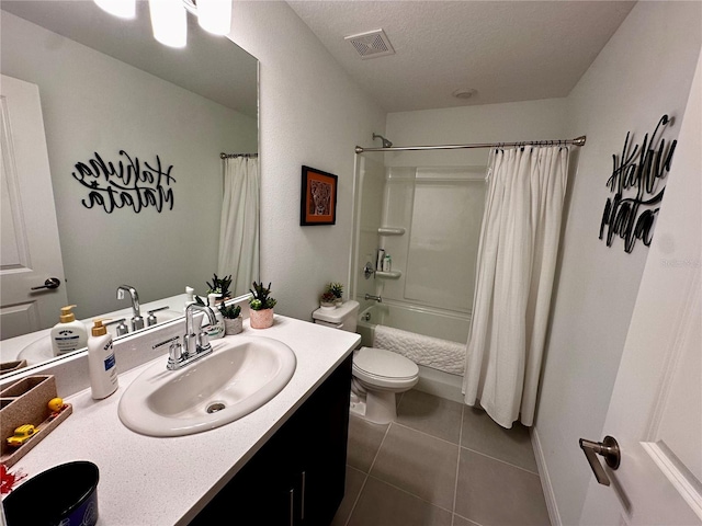 full bathroom featuring tile patterned flooring, a textured ceiling, toilet, shower / tub combo with curtain, and vanity