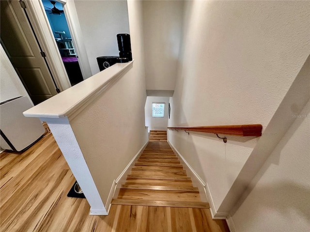 stairs featuring hardwood / wood-style floors