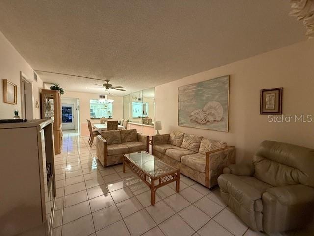 tiled living room featuring a textured ceiling and ceiling fan