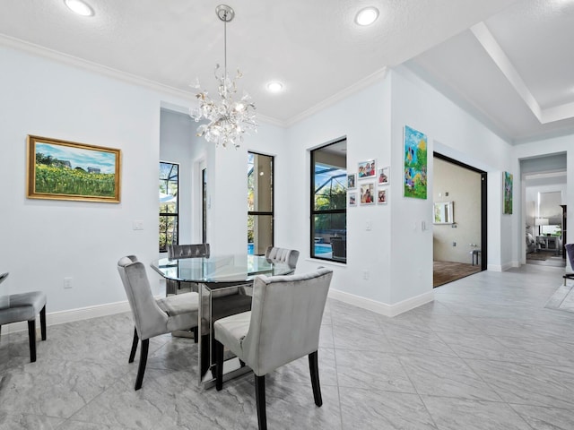 dining room with crown molding, a textured ceiling, and a notable chandelier