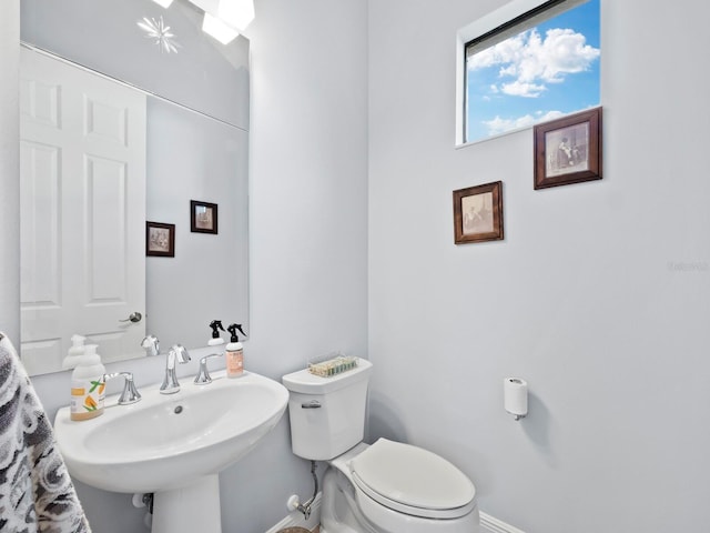 bathroom featuring toilet and sink