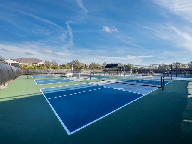 view of tennis court featuring basketball hoop