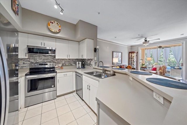 4106 Central Sarasota Pkwy Unit 1026, Sarasota, FL 34238 - kitchen featuring stainless steel appliances, a sink, light tile patterned flooring, light countertops, and backsplash