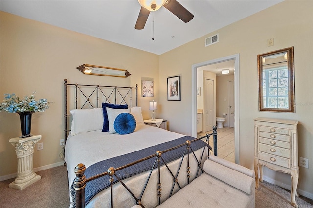 carpeted bedroom with ceiling fan and ensuite bathroom