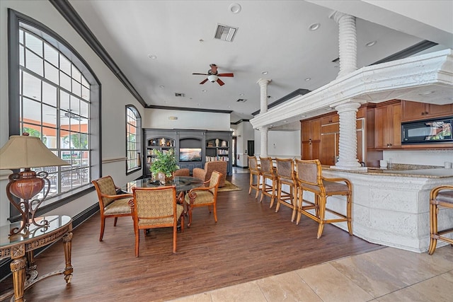 4106 Central Sarasota Pkwy Unit 1026, Sarasota, FL 34238 - dining space featuring ornate columns, ornamental molding, a ceiling fan, light wood finished floors, and recessed lighting