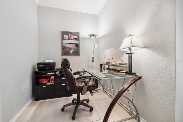 office area featuring light wood-type flooring and crown molding