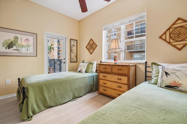 bedroom featuring access to exterior, ceiling fan, and light hardwood / wood-style flooring