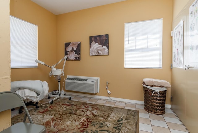 living area with light tile patterned floors and an AC wall unit