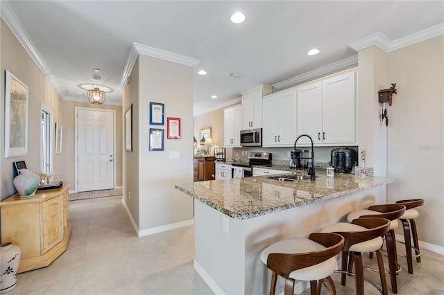 kitchen with white cabinets, sink, kitchen peninsula, and stainless steel appliances