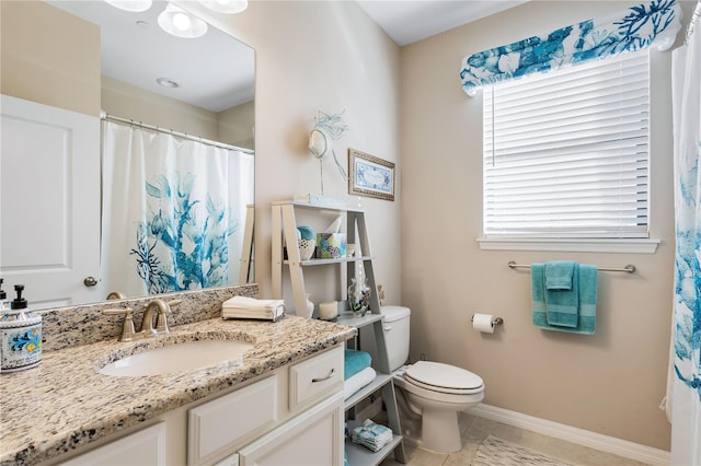 bathroom with tile patterned floors, vanity, and toilet