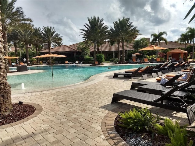 view of pool featuring pool water feature and a patio area