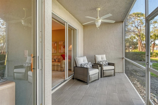 unfurnished sunroom featuring ceiling fan