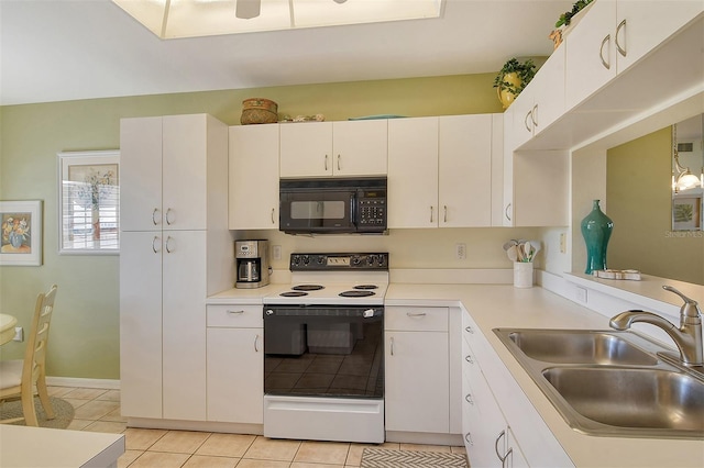 kitchen with white cabinetry, sink, hanging light fixtures, white range with electric cooktop, and light tile patterned floors