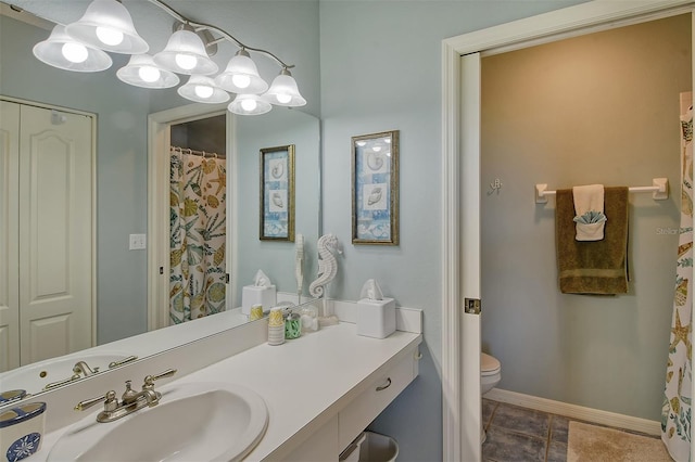 bathroom with tile patterned flooring, vanity, and toilet