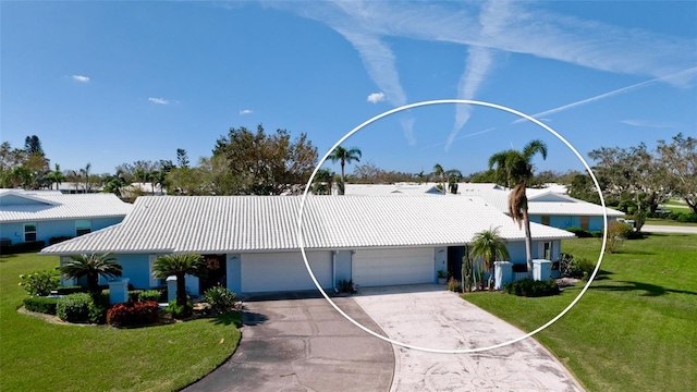 view of front of property featuring a garage and a front lawn