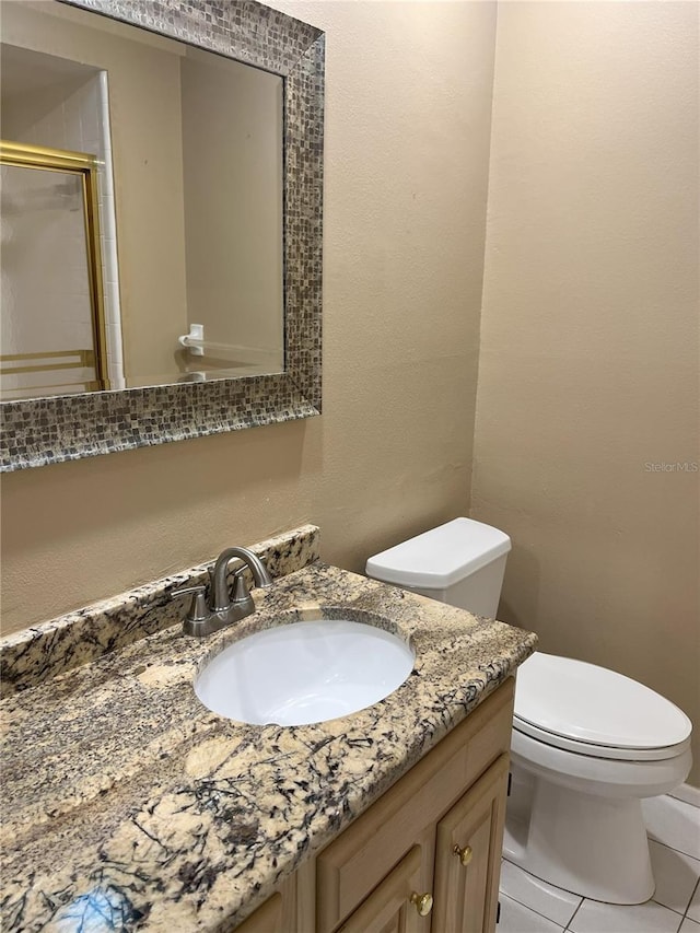 bathroom with tile patterned floors, toilet, and vanity