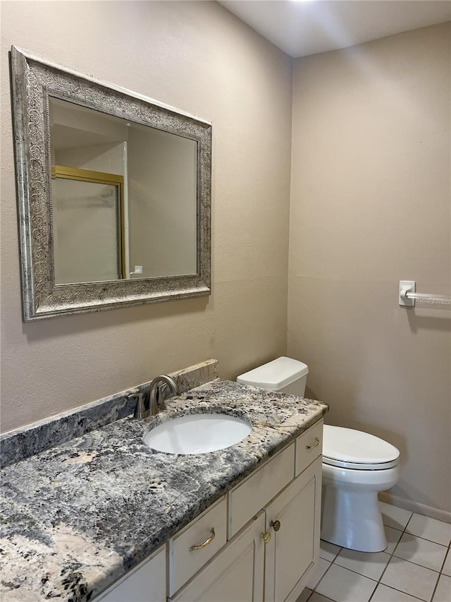 bathroom with vanity, tile patterned floors, and toilet