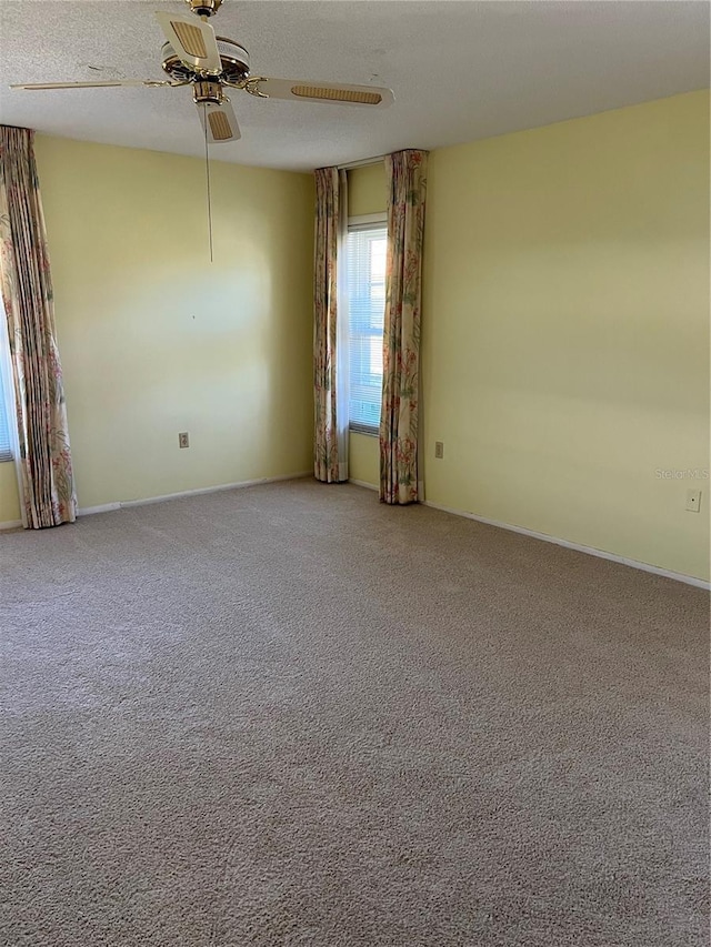 spare room with ceiling fan and carpet floors