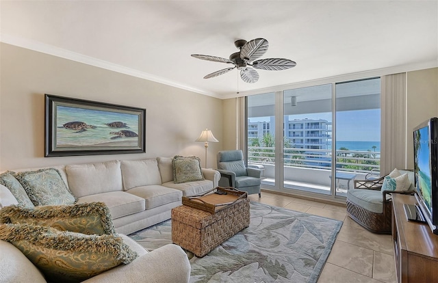 tiled living room featuring floor to ceiling windows, ornamental molding, and ceiling fan