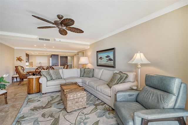 living room with ceiling fan and ornamental molding