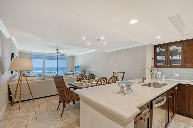 kitchen featuring dishwasher, sink, crown molding, ceiling fan, and decorative backsplash