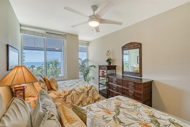 bedroom featuring multiple windows and ceiling fan