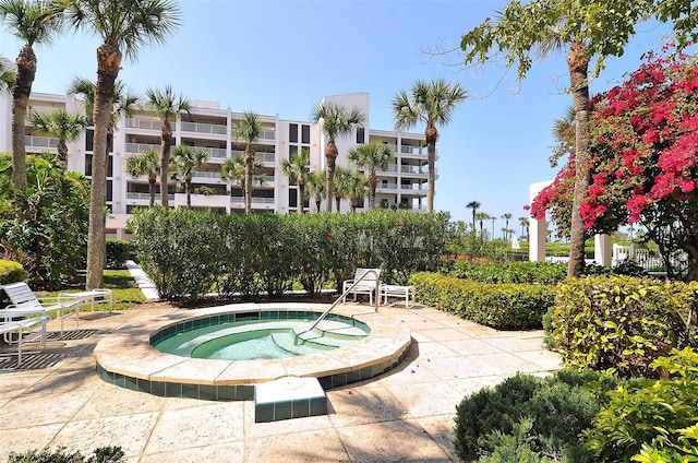 view of swimming pool featuring a community hot tub