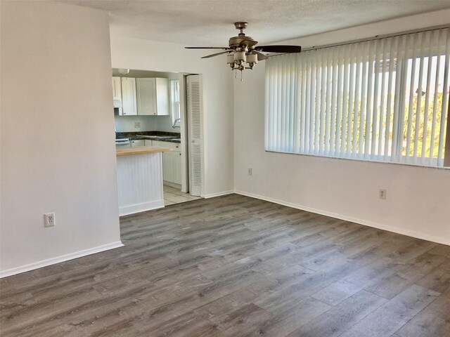 4480 Ironwood Cir Unit 218A, Bradenton, FL 34209 - unfurnished living room with healthy amount of natural light, a sink, wood finished floors, and ceiling fan