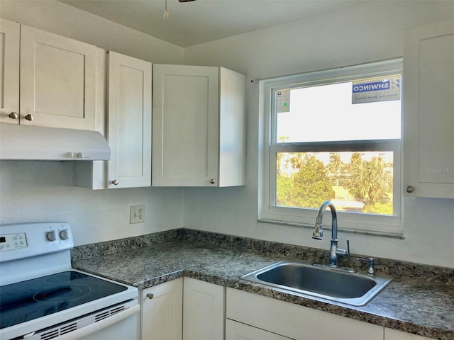 kitchen with sink, white cabinetry, a healthy amount of sunlight, and electric stove