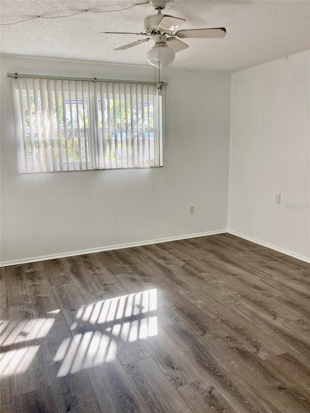 4480 Ironwood Cir Unit 218A, Bradenton, FL 34209 - unfurnished room featuring healthy amount of natural light, wood finished floors, ceiling fan, a textured ceiling, and baseboards
