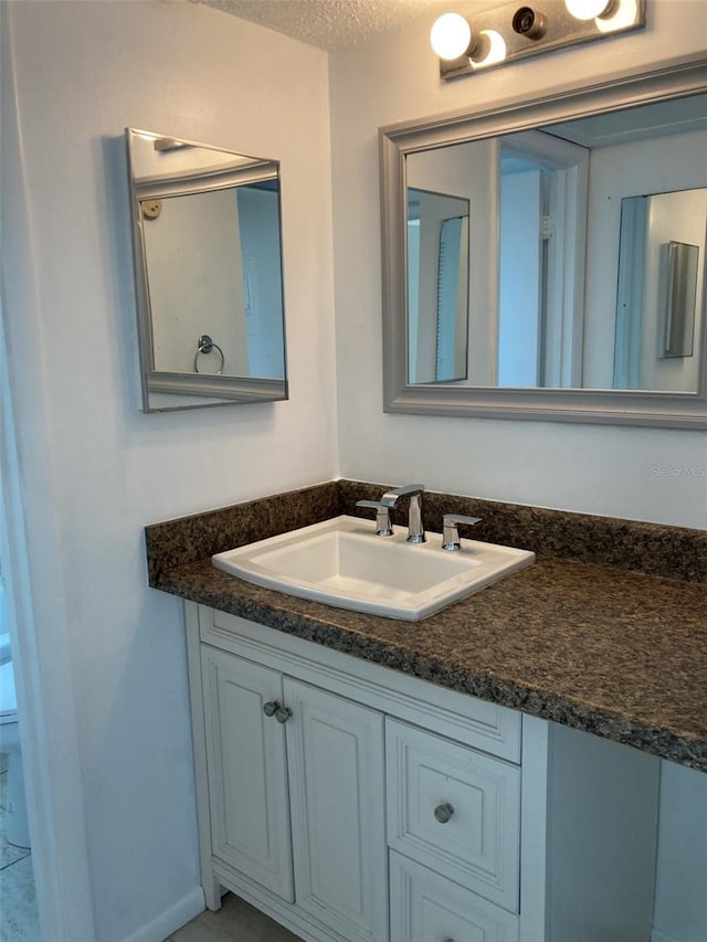 bathroom featuring vanity and a textured ceiling