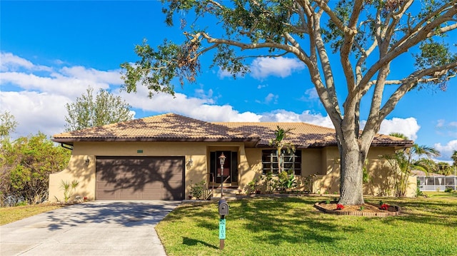 view of front of property featuring a garage and a front yard