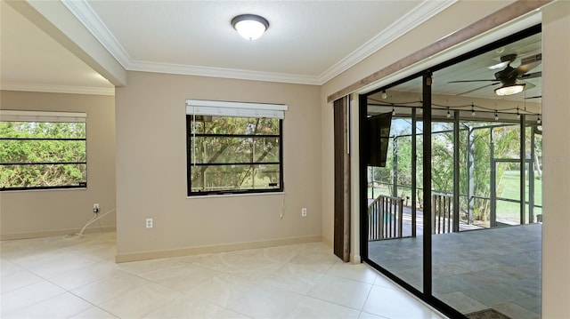 empty room featuring plenty of natural light, crown molding, and ceiling fan